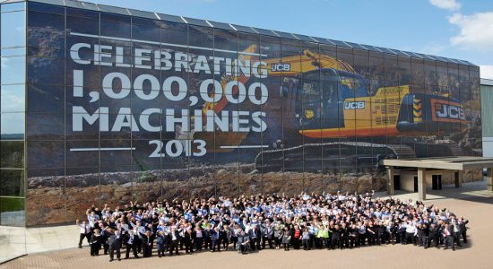 Employees celebrate the production of JCB's one millionth machine in Staffordshire