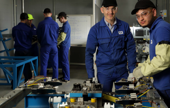 Muzakkir ‘Muz’ Hussain, a press shop production operative Level 2 apprentice, who started his employment with Unipres in September 2017. Shown here with tutor/assessor Steve Simm, a press shop specialist. The equipment they are using is a simulator for a transfer press finger jig. Muz is learning how to set the position of the fingers, an essential skill for processing panels of steel within the various production presses.