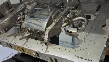 advanced manufacturing MetLase six-axis robotic welding modular assembly fixture for lightweight exhaust system.