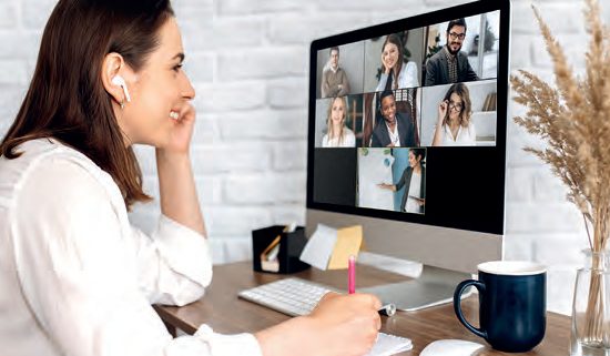 Video call. Remote work. A girl work from home. She communicate via video communication with colleagues using computer - Shutterstock