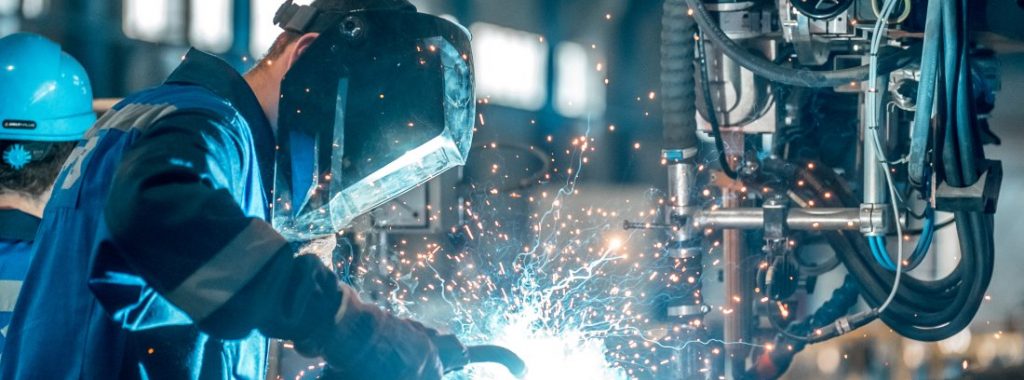 stock-image-of-person-welding-in-manufacturing-facility-shutterstock