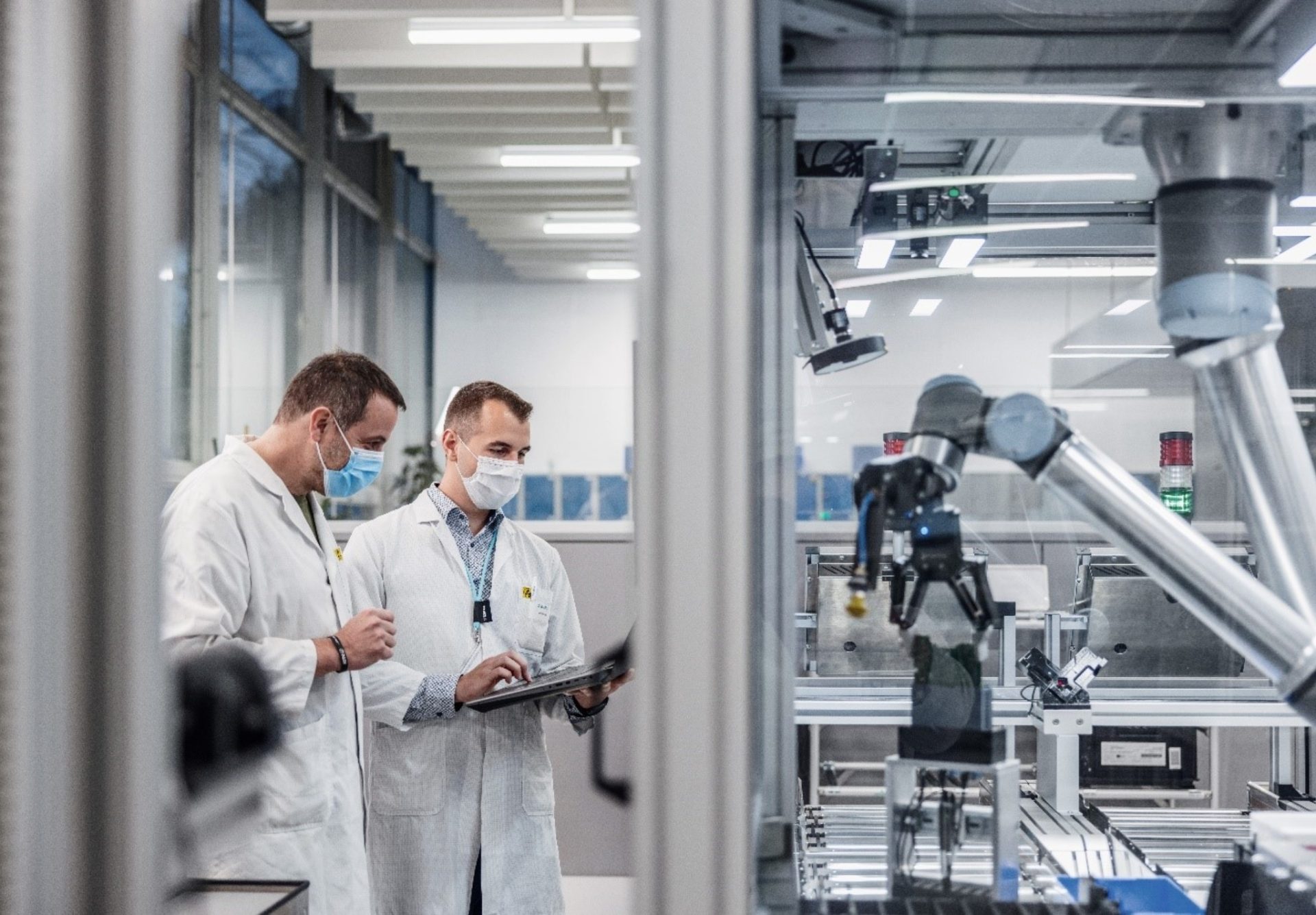 Engineer operates a cobot, enhancing teamwork between humans and machines. (Image of Siemens’ manufacturing and development site in Karlsruhe, credit: Getty Images)